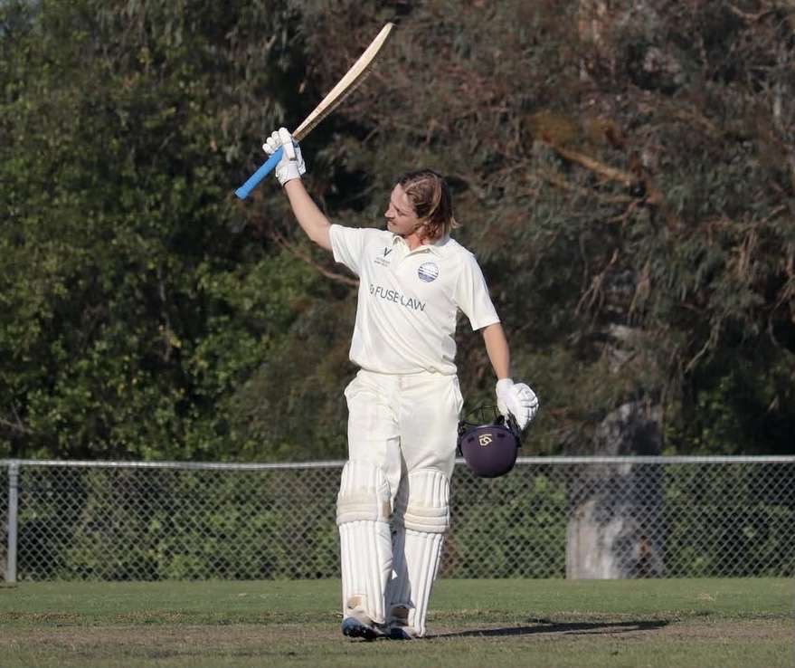 Lachie raising his bat after a milestone