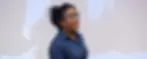 Image description: a photo of Izzy Jayasinghe, a brown woman, speaking. She has dark curly hair, which is tied up. She is wearing a navy blue shirt and glasses. Image credit: The Scientist (Williams, 2021)
