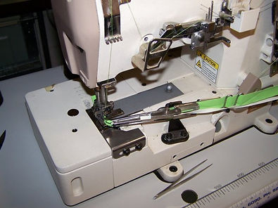 close up photo of binder on an industrial cover stitch machine