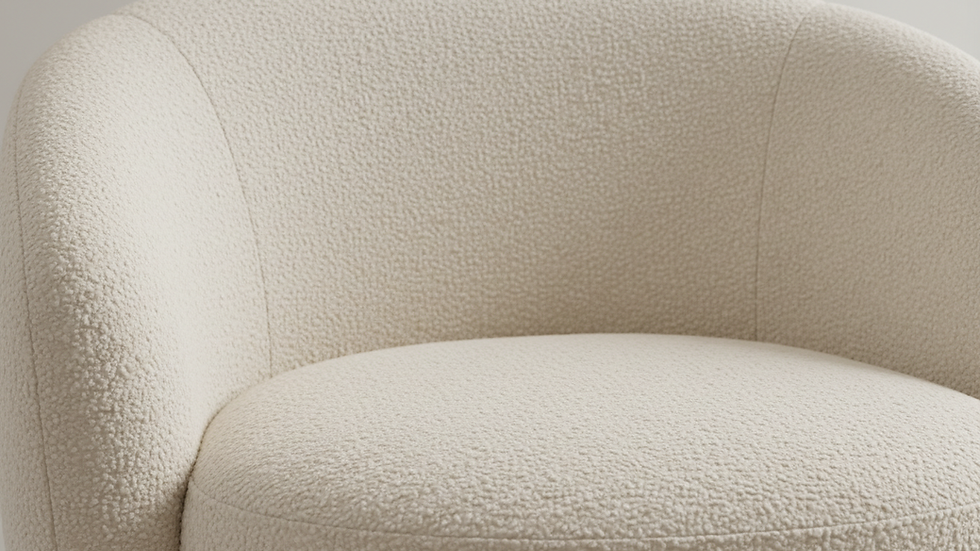 Close-up view of boucle fabric texture on a cream armchair