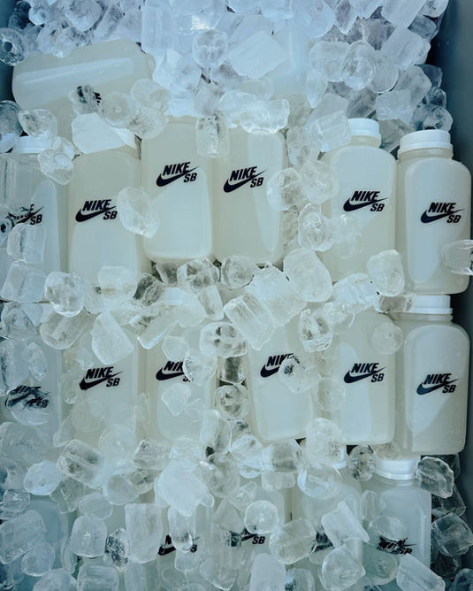 Mobile juice cart rental featuring branded bottled drinks served over ice