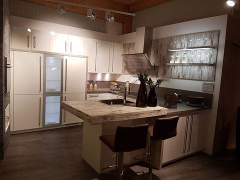 White high gloss contemporary kitchen with bartop seating.