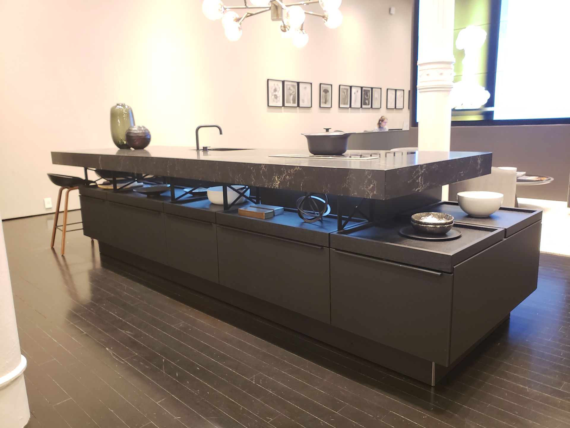 This German kitchen design by Poggenpohl offers a kitchen island with open shelving between countertop and base units.