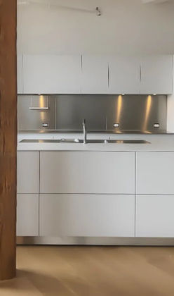 White Loft kitchen with stainless steel and white countertop.