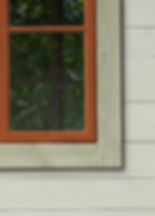 Gray house with light green trim and red ochre window