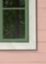 Pink house with white trim and green window