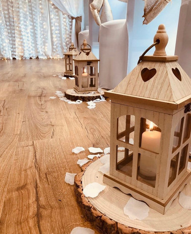 Wooden lanterns on log slices for wedding ceremony