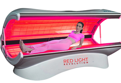 person on red light bed