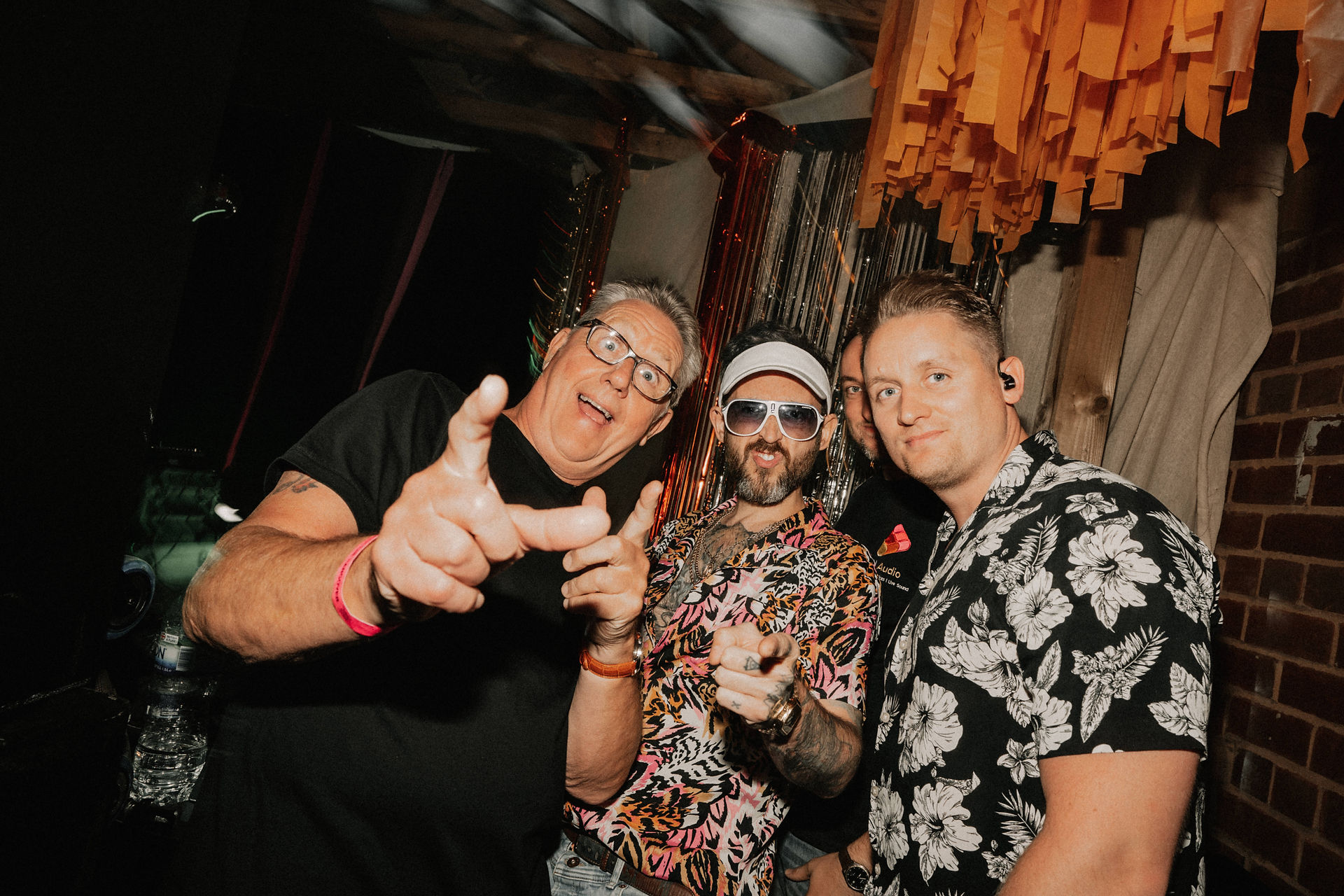 three men all posing for camera