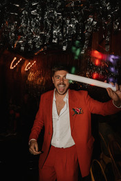 guests dancing with glowsticks on dancefloor at wedding