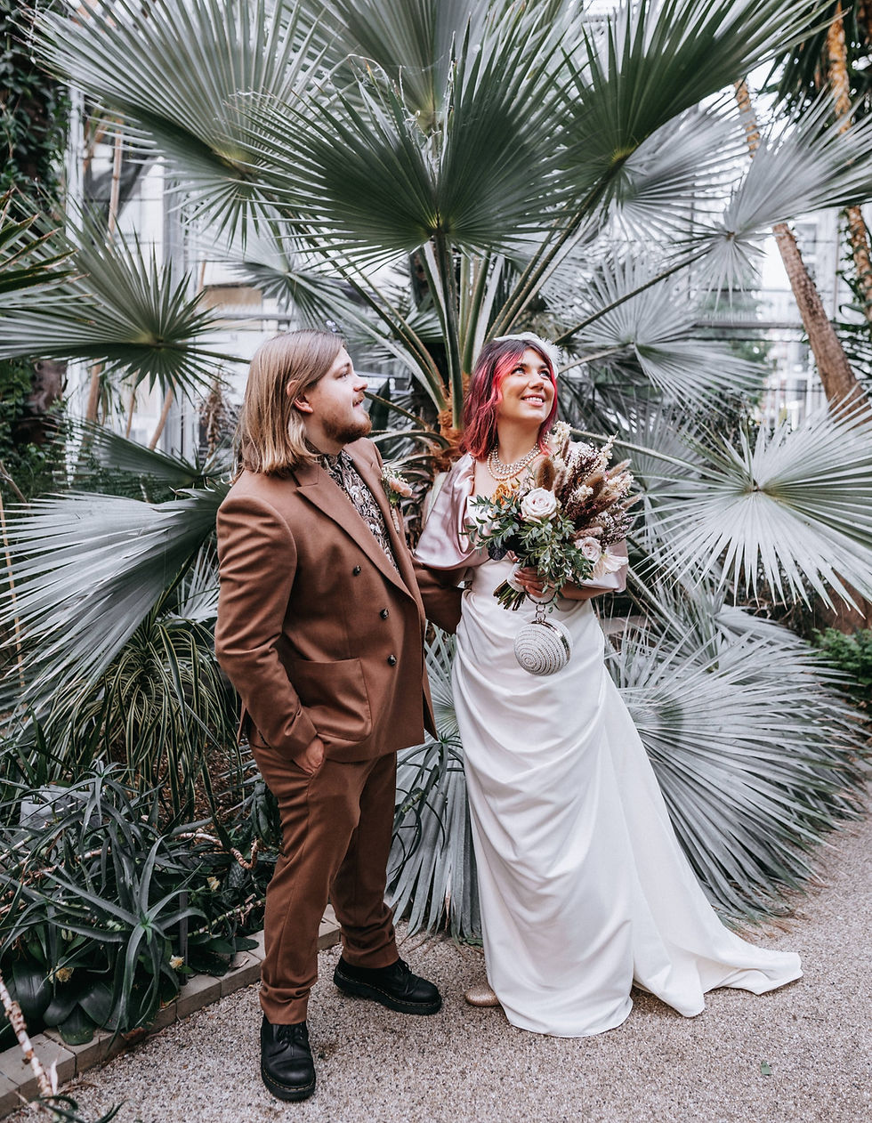 BRIDE AND GROOM IN GREENHOUSE