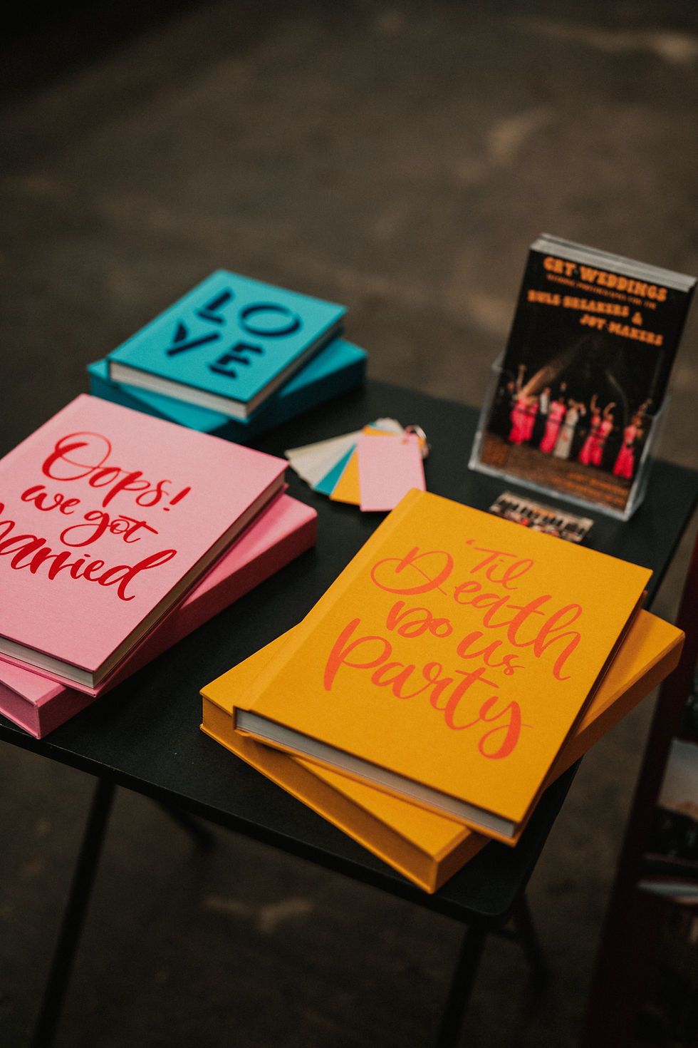 3 coffee table albums, pink blue and yellow