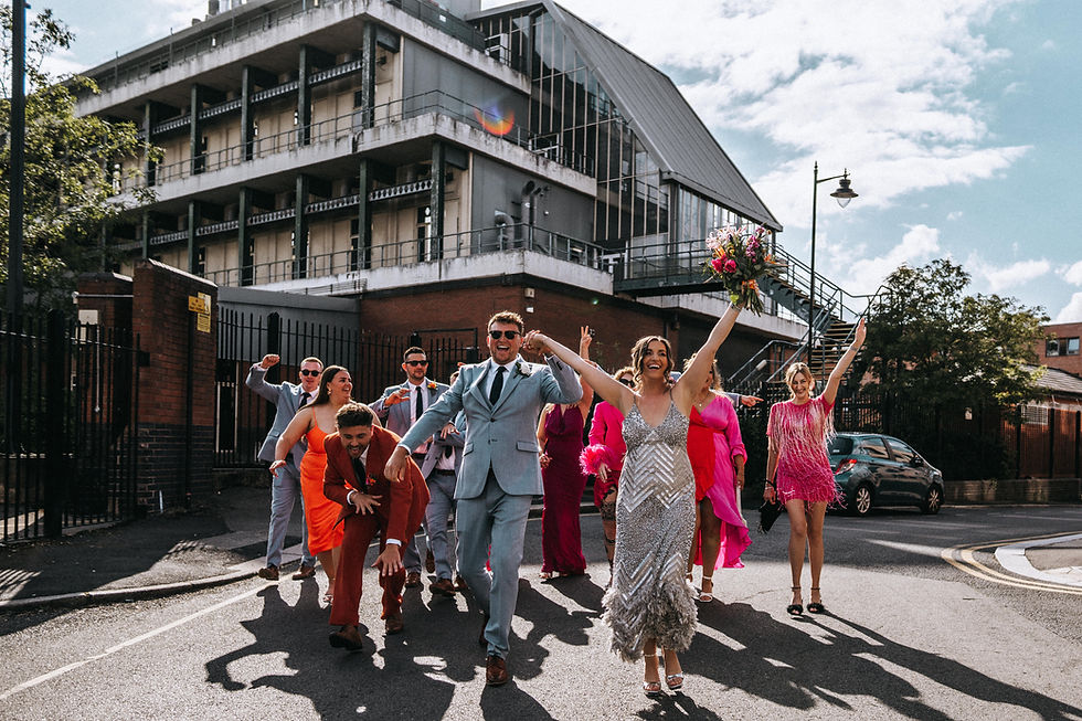 bride and groom with bridesmaids and groomsmen being silly posing for camera