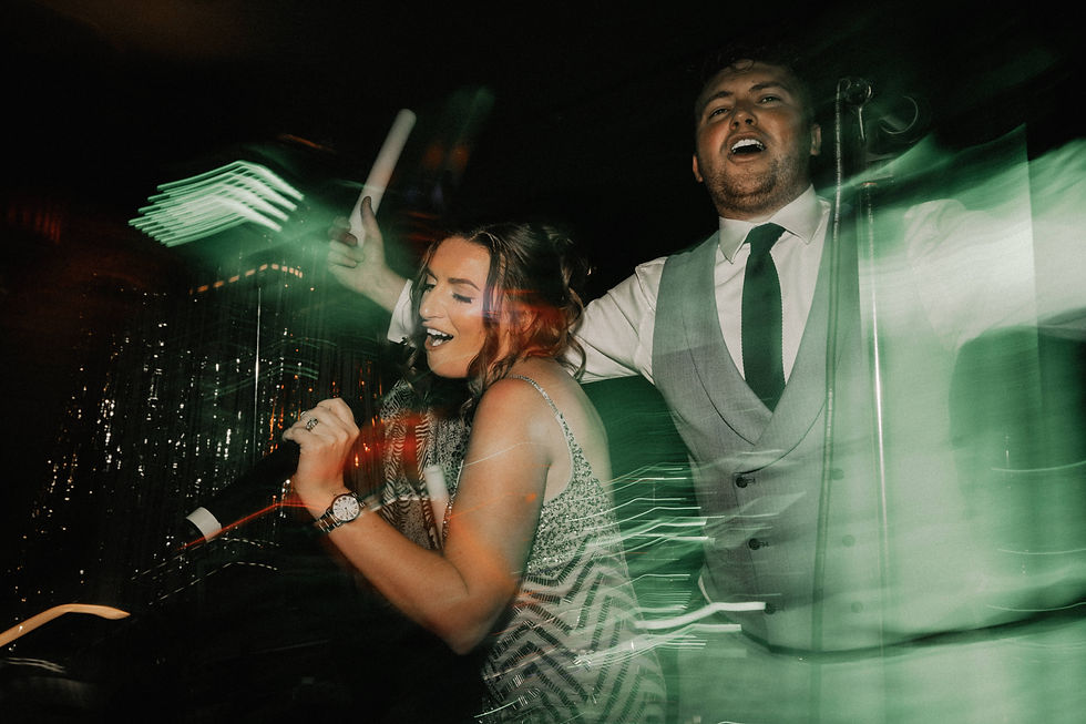 Bride and groom singing with the band
