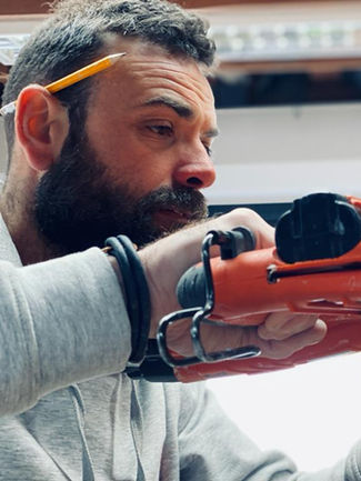Bespoke Under-Stairs Storage with Pull-Out Shoe Drawer Hanging Rail Shelving and Wine Rack for a Client's Hallway in Reigate Surrey by New Heights Carpentry