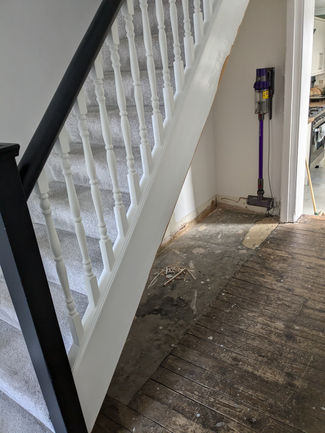 Bespoke Under-Stairs Storage with Pull-Out Shoe Drawers and Custom Shelving for Clients in Reigate Surrey by New Heights Carpentry.