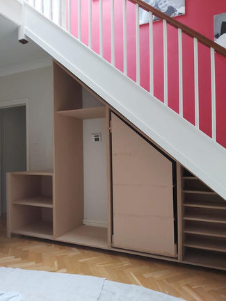 Bespoke Under-Stairs Storage with Pull-Out Shoe Drawer Hanging Rail Shelving and Wine Rack for a Client's Hallway in Reigate Surrey by New Heights Carpentry