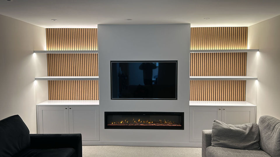 Large Wall-to-Wall TV Media Unit with Electric Fireplace LED Lighting Cupboards with Shaker Style Soft-Closing Doors and Shelving for a Customer in West Sussex by New Heights Carpentry