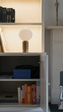 Bespoke alcove units with integrated LED shelf lighting, Shaker-style cabinets and a professional spray finish, handcrafted and installed by New Heights Carpentry in Surrey.