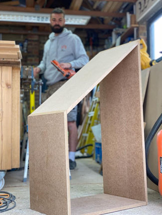 Bespoke Under-Stairs Storage with Pull-Out Shoe Drawer Hanging Rail Shelving and Wine Rack for a Client's Hallway in Reigate Surrey by New Heights Carpentry