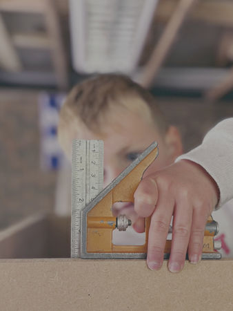 Carl’s son learning carpentry skills in the workshop, the little apprentice at New Heights Carpentry