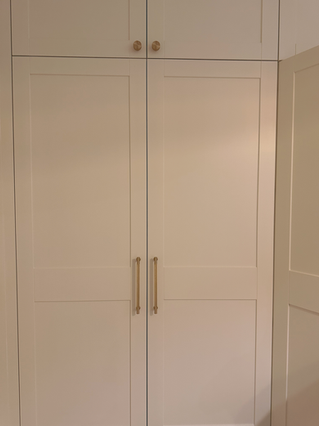 Shaker style fitted wardrobe featuring bespoke shelving, drawers and hanging rails by New Heights Carpentry in Reigate, Surrey. Custom-built for functional and stylish storage.