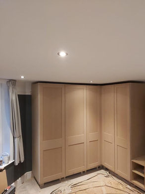 Shaker style fitted wardrobe featuring bespoke shelving, drawers and hanging rails by New Heights Carpentry in Reigate, Surrey. Custom-built for functional and stylish storage.