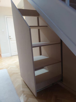 Bespoke Under-Stairs Storage with Pull-Out Shoe Drawer Hanging Rail Shelving and Wine Rack for a Client's Hallway in Reigate Surrey by New Heights Carpentry