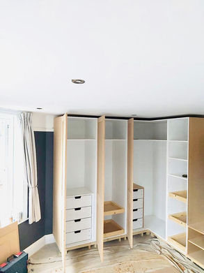 Shaker style fitted wardrobe featuring bespoke shelving, drawers and hanging rails by New Heights Carpentry in Reigate, Surrey. Custom-built for functional and stylish storage.