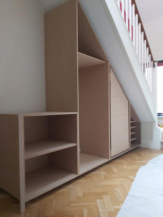 Bespoke Under-Stairs Storage with Pull-Out Shoe Drawer Hanging Rail Shelving and Wine Rack for a Client's Hallway in Reigate Surrey by New Heights Carpentry