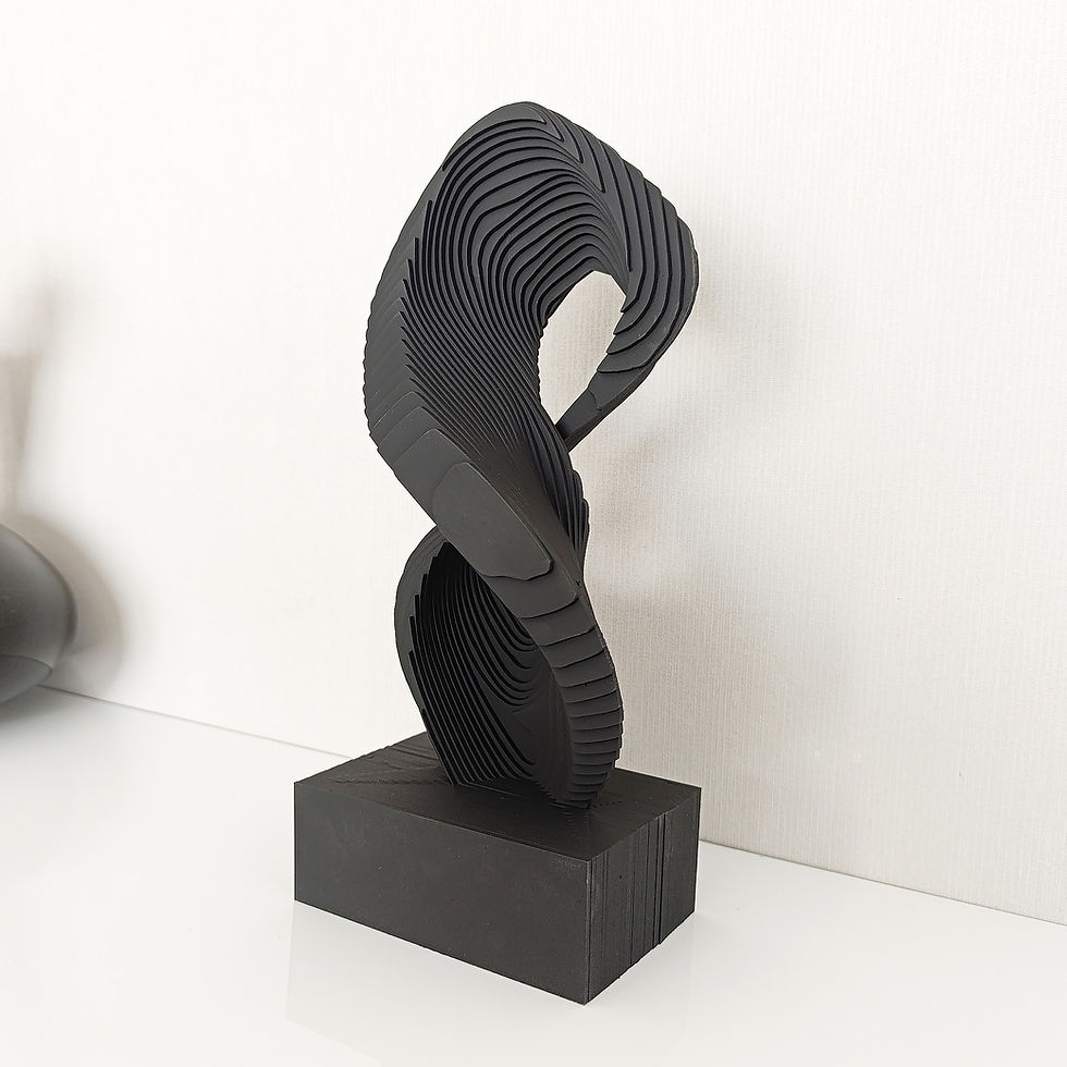 Thumbnail: A handcrafted wooden sculpture featuring a fluid infinity-like form made of layered wood sheets