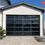 Thumbnail: Black Aluminum Garage Door with Black Reflective Glass Insets