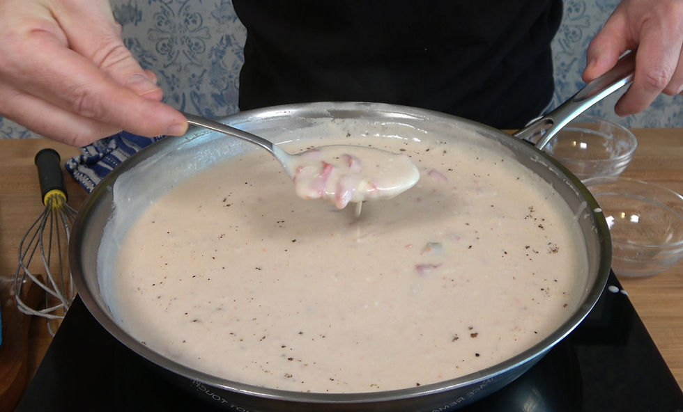 A rich and creamy cheese sauce is being prepared to ensure the chicken enchiladas remain moist and flavorful.