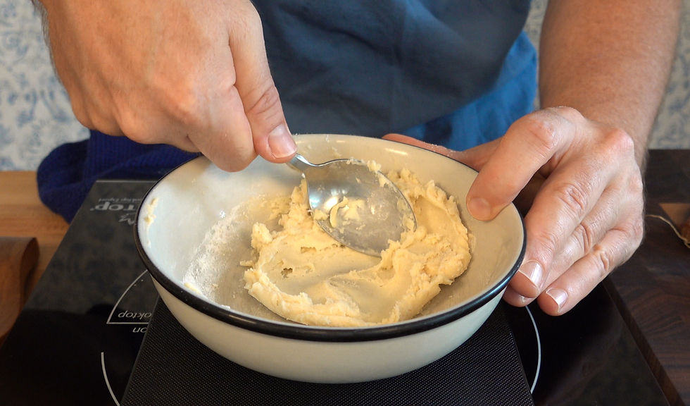 Mixing flour and butter to create a smooth beurre manié, a classic thickening agent for sauces and soups.
