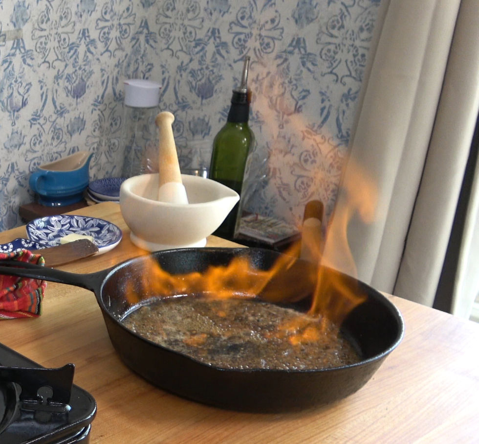 A sizzling flambe of cognac adds a fiery touch to the preparation of sauce au poivre in a rustic kitchen setting.
