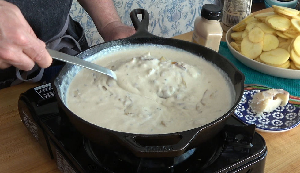 Stirring a homemade creamy sauce on the stovetop, perfecting the recipe for delicious scalloped potatoes recipe.