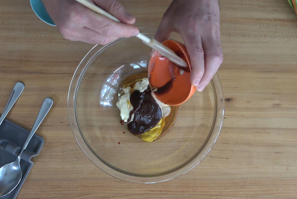 Adding BBQ sauce to a mix of mayonnaise, mustard, and honey for a homemade Chick-fil-A copycat sauce.