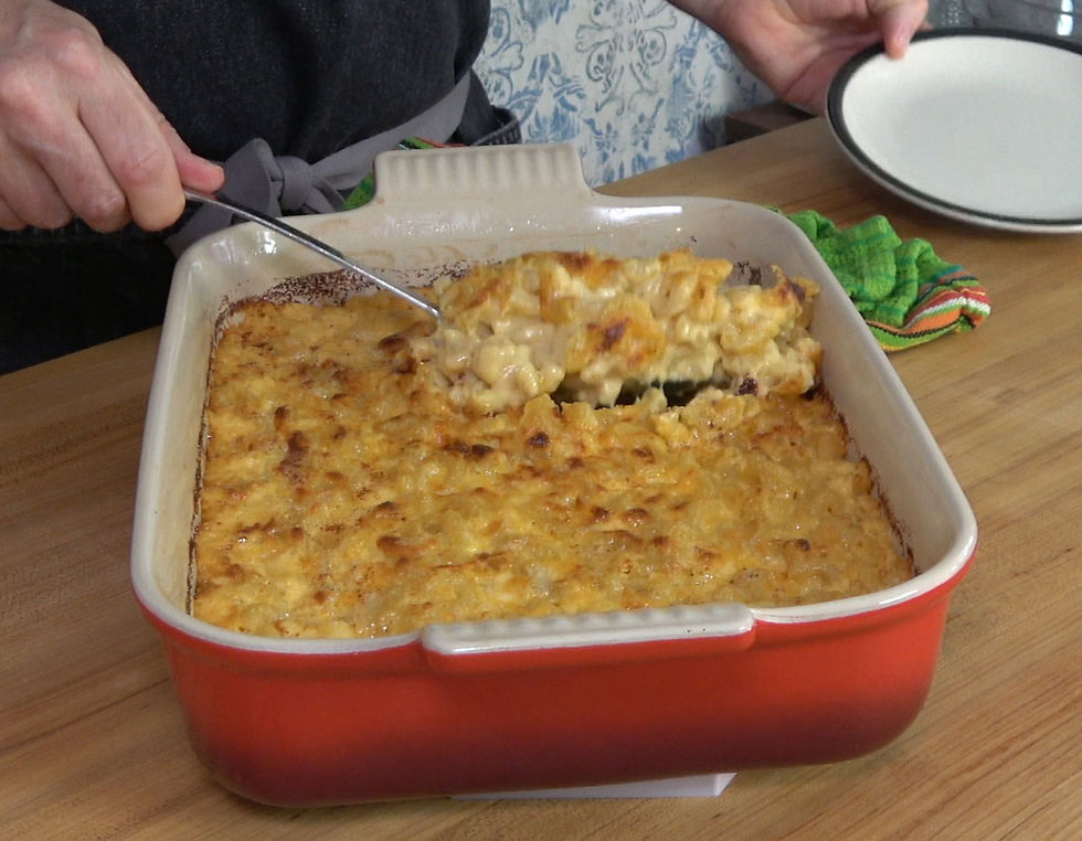 Serving a delicious portion of creamy Chick-fil-A mac and cheese from a freshly baked dish.