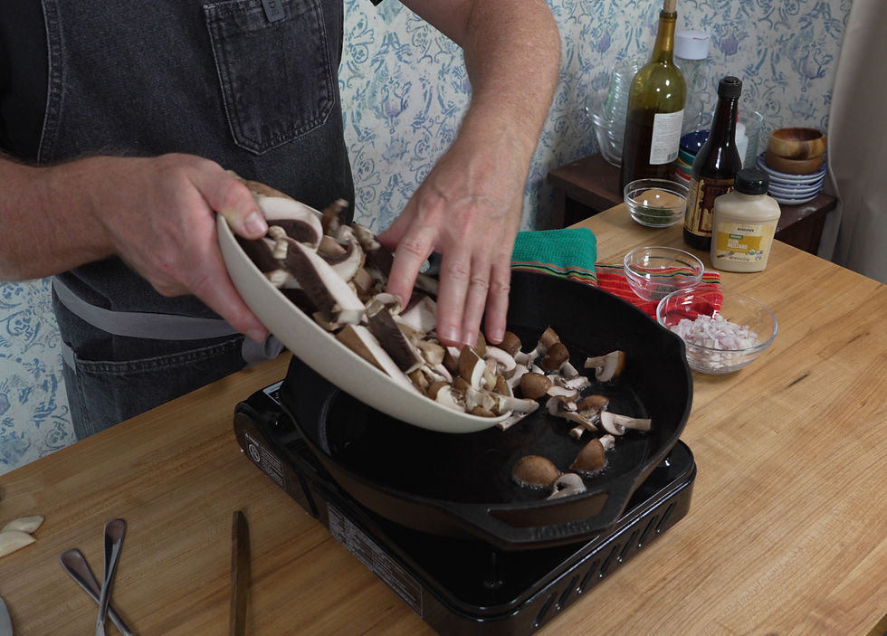 Adding fresh mushrooms to the skillet, prepping for a delicious homemade creamy mushroom gravy.