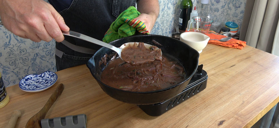 Johnny Mac prepares a rich shallot pan sauce in a cast iron skillet, ready to enhance the flavor of a perfectly cooked steak.