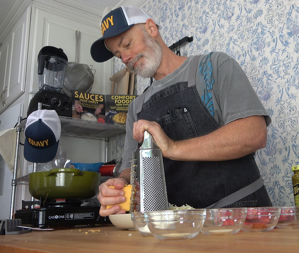 Preparing for a delicious smooth homemade nacho cheese sauce, carefully shredding cheese in the kitchen.