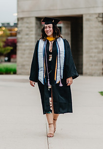 Kayla wears her cap and gown during her graduation photos on Roger Williams University campus in Rhode Island