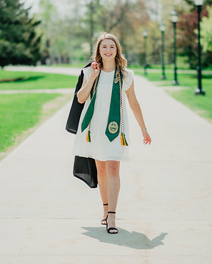 Courtney walks on UVM campus during her college graduation photoshoot