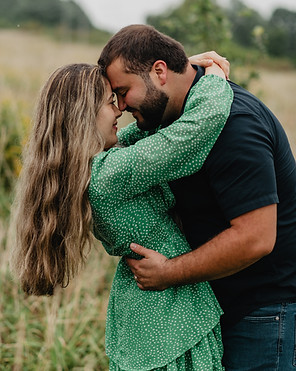 A couple embrace and touch their foreheads to each other during a couples photoshoot in Colchester Vermont