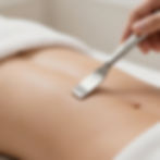 Advanced Clinical Skincare treatment on abdomen with silver tool