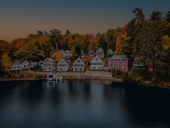 An aerial view of homes on Lake Winnepesauke, New Hampshire during peak foliage season._ed