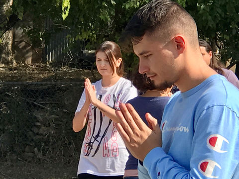 A young man in Buddhist prayer pose