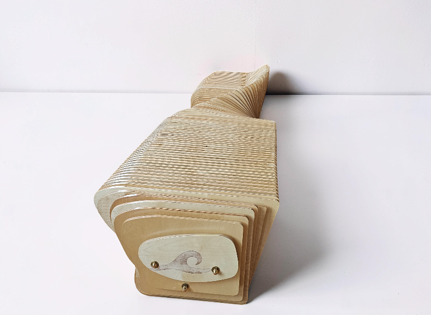 Custom bench with sculptural parametric design on a white background.