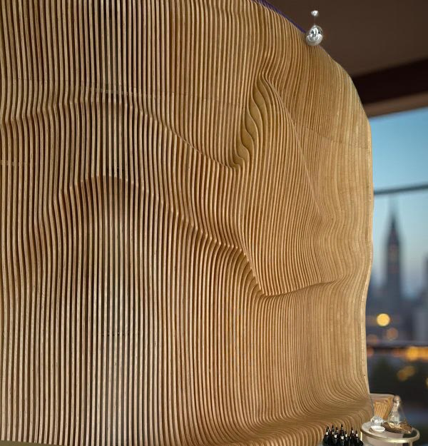 Parametric wooden wall panel with sculptural CNC-cut waves, handcrafted from premium plywood for modern interiors.