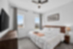 Furnished bedroom with queen bed and modern decor
